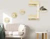 A cat tree and wall-mounted cat shelves are displayed on a wall above a sofa in a living room. Náhled obrázku produktu