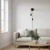 A modern living room with a sofa, coffee table, and a wall lamp. Produktbild-Vorschau