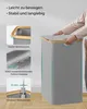 A person's hands are shown interacting with a grey laundry basket with a wooden rim. Náhled obrázku produktu