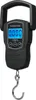 A black portable digital scale with a hook is shown against a white background. Produktbild-Vorschau