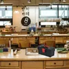 A workshop or studio setting with tools and equipment on wooden workbenches. Produktbild-Vorschau