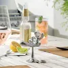 A chrome bottle opener shaped like a rodeo rider sits on a wooden table with drinks and citrus fruits. Náhľad obrázku produktu