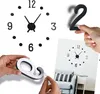 Hands assembling a wall clock with numbers and hands. Náhled obrázku produktu