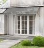 An awning is installed over a set of glass doors on the exterior of a house. Produktbild-Vorschau