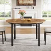 A round dining table set in a dining room with a fireplace in the background. Podgląd zdjęcia produktu