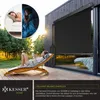 A woman relaxing on a lounge chair outdoors, with a building and a large roller blind in the background. A circular inset shows two scenes of people sleeping. Produktbild-Vorschau
