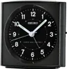 A close-up of a black Seiko alarm clock with a black face and white numbers and hands. Anteprima dell’immagine prodotto