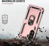 A rose gold phone case with a ring stand is shown in a dynamic, action-oriented scene with debris flying around it, suggesting durability and protection. Produktbild-Vorschau