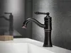 A black and bronze vintage-style faucet is shown on a white sink with a gray textured wall in the background. Náhľad obrázku produktu