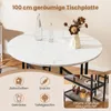 A round dining table with a marble-like surface, set with two bottles of water and a vase with dried flowers. The image also includes icons and text describing the table's features and storage. Podgląd zdjęcia produktu