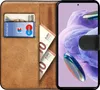 A book-style phone case with cards and cash inside, displaying a smartphone screen. Produktbild-Vorschau