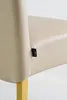 A close-up shot of a chair's upholstery and leg. Produktbild-Vorschau
