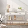A white desk with shelves, drawers, books, a lamp, and a plant, next to a white office chair. Anteprima dell’immagine prodotto