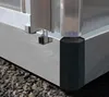 A close-up view of the corner of an aluminum greenhouse structure, showing the base and a black protective corner piece. Náhled obrázku produktu