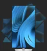 A vertical monitor displaying a blue abstract wallpaper, with other monitors angled behind it. Produktbild-Vorschau