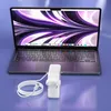 A laptop and its charger are displayed on a reflective purple surface. Produktbild-Vorschau