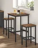A bar table set with two stools placed near a window. Breakfast items are on the table. Náhled obrázku produktu