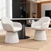 Two beige upholstered chairs are placed on a tan rug in a modern dining or living room setting. Podgląd zdjęcia produktu