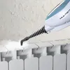 A steam mop is being used to clean a white radiator, with steam visibly rising. Náhled obrázku produktu