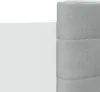Close-up of a white wall and a grey upholstered headboard. Anteprima dell’immagine prodotto