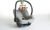 A baby car seat with a mobile attached. Voir les images du produit