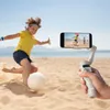 A child plays soccer on a beach while a smartphone is being filmed with a gimbal. Voir les images du produit