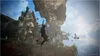 A person is swinging on a rope in front of a crumbling, ancient building. Náhled obrázku produktu