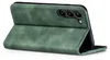 A green flip case for a smartphone is shown from a side angle, propped open. Produktbild-Vorschau