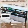 A bed frame with a headboard featuring storage and a charging station, shown in a bedroom setting. Náhled obrázku produktu