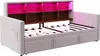 A light gray upholstered daybed with a built-in bookshelf headboard illuminated with pink LED lights. Voir les images du produit