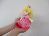 Hands holding a Princess Peach plush toy. Náhľad obrázku produktu