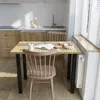 A kitchen scene with a table and chairs, set for a meal. Produktbild-Vorschau