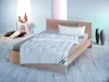 A neatly made bed with a white duvet and pillow in a bright, minimalist room. Produktbild-Vorschau