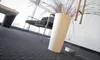 An office or waiting room setting with a large white planter in the foreground. Anteprima dell’immagine prodotto