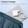 A white USB-C charger and cable are placed on top of a laptop, which is partially inside a blue bag. Produktbild-Vorschau
