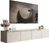 A modern beige TV stand with gold trim, topped with decorative items and a framed picture of a spiral staircase above it. Produktbild-Vorschau