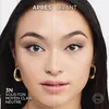 A split image showing a woman's face, with the left side showing the 'after' effect of a makeup product and the right side showing the 'before'. Text indicates the product shade and tone. Voir les images du produit