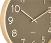 Close-up of a wall clock face showing the numbers 7 through 12, with the hands pointing to approximately 9:10. Produktbild-Vorschau
