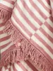 A close-up view of a pink and white striped blanket with fringe. Produktbild-Vorschau