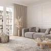 A modern living room with a gray sofa, a wooden coffee table, and a patterned rug. Náhled obrázku produktu