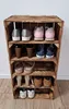 A wooden shoe rack made from crates, filled with various shoes. Náhled obrázku produktu