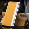 A yellow flip case for a smartphone is shown in a studio setting. Produktbild-Vorschau