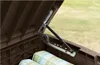 Close-up view of the interior of a brown storage box, showing a hydraulic lift mechanism and cushions. Produktbild-Vorschau
