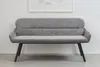 A gray upholstered bench with black legs is shown against a white wall with a framed picture above it. Produktbild-Vorschau