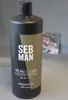 A bottle of Sebastian Professional Man The Multi-Tasker shampoo is shown in front of a blurred photograph of a person wearing a hat. Náhled obrázku produktu