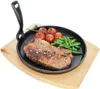 A cast iron pan with a steak, cherry tomatoes, and green beans on a wooden board. Náhled obrázku produktu