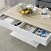 A close-up view of a modern coffee table with open drawers, showcasing its storage capacity and design. Náhled obrázku produktu