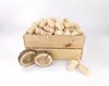 A wooden crate filled with fire starters, with two wood slices and a few fire starters in front. Produktbild-Vorschau