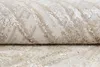 A close-up view of a rolled-up rug with a textured pattern. Produktbild-Vorschau