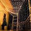 A balcony decorated with warm white string lights and a Christmas tree. Produktbild-Vorschau